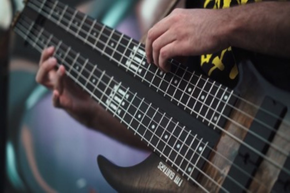 A musician playing a double neck bass